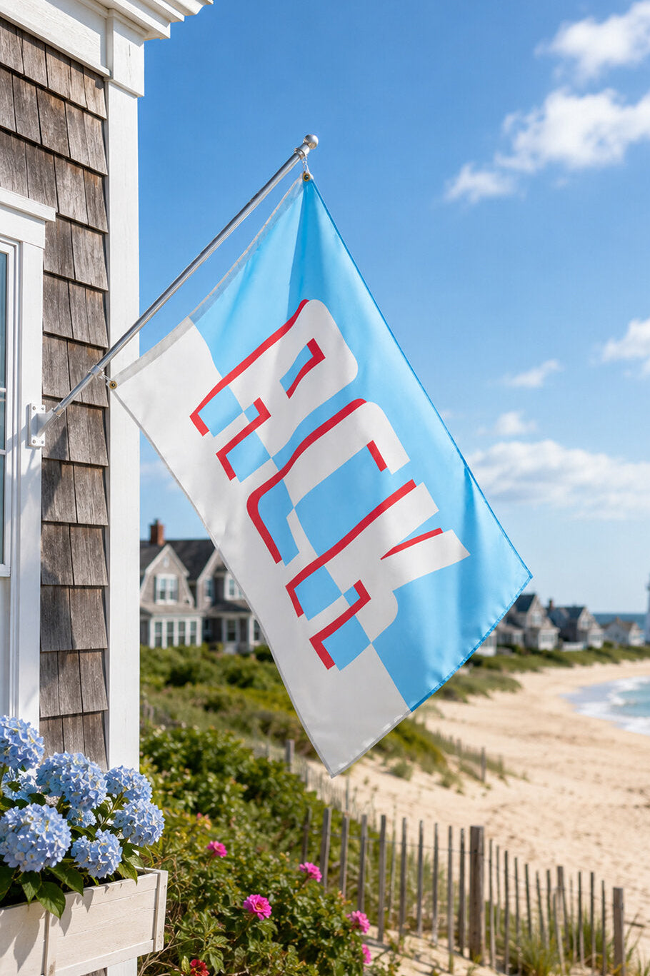 Modern Nantucket house flag displayed outside a classic coastal cottage.